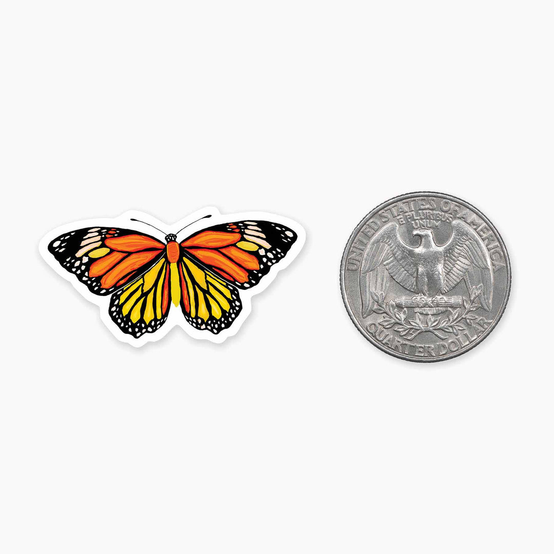 A cell phone sticker slightly larger than the size of a quarter of a colorful monarch butterfly with its wings spread.
